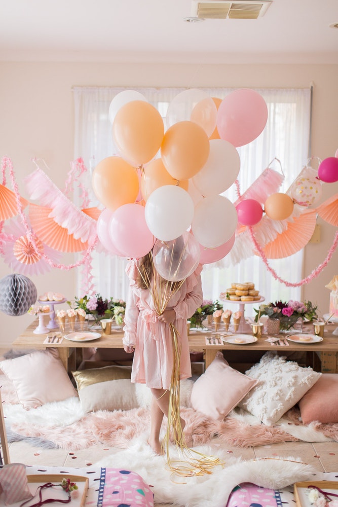 boho slumber party, peach pinch and white slumber party, pretty girl's party, glamping party, gorgeous slumber party, slumber party ideas, pink peach white party tassel feather garland, fabric teepee tent slumber party, sleepover ideas