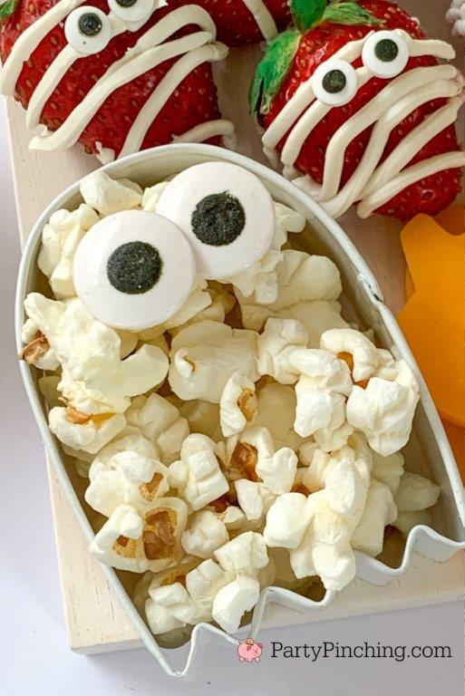 ghost cookie cutter popcorn, halloween charcuterie, spook-cuterie board, best charcuterie board ideas, easy charcuterie board, charcuterie for kids, halloween partie ideas, easy best charcuterie board ideas, healthy charcuterie board for kids