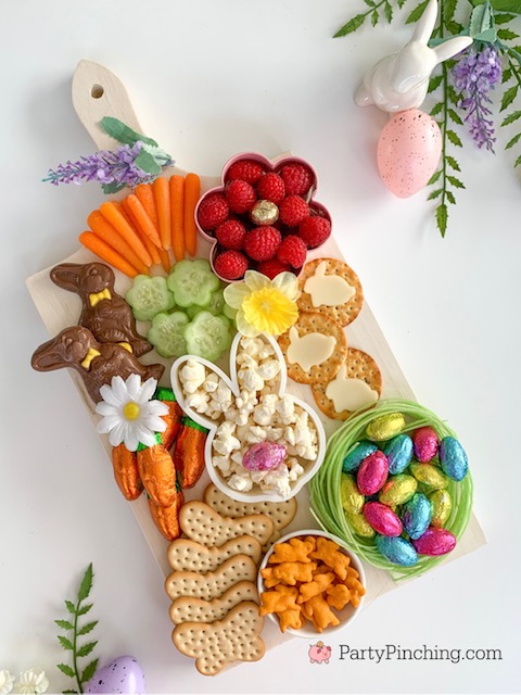 Easter snack board, Easter charcuterie board, Easter candy board, best charcuterie board ideas, best Easter charcuterie board, chocolate bunny charcuterie board, healthy charcuterie board for kids, cookie cutter charcuterie board, Easter candy charcuterie board, bunny cheese crackers, chocolate carrots, butterfly crackers, bunny cheese , foil covered eggs, R.M. Palmer