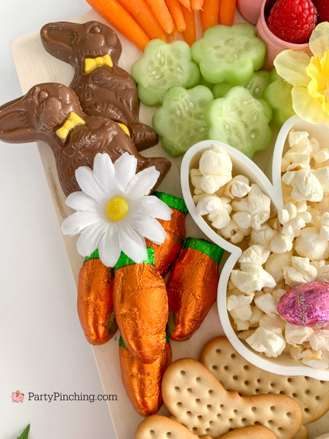 Easter snack board, Easter charcuterie board, Easter candy board, best charcuterie board ideas, best Easter charcuterie board, chocolate bunny charcuterie board, healthy charcuterie board for kids, cookie cutter charcuterie board, Easter candy charcuterie board, bunny cheese crackers, chocolate carrots, butterfly crackers, bunny cheese , foil covered eggs, R.M. Palmer