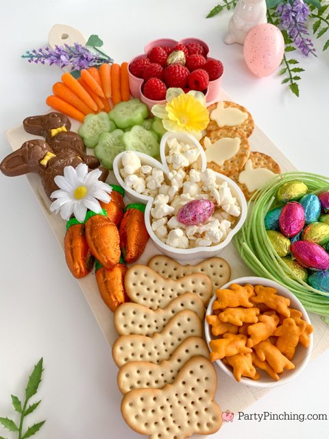 Easter snack board, Easter charcuterie board, Easter candy board, best charcuterie board ideas, best Easter charcuterie board, chocolate bunny charcuterie board, healthy charcuterie board for kids, cookie cutter charcuterie board, Easter candy charcuterie board, bunny cheese crackers, chocolate carrots, butterfly crackers, bunny cheese , foil covered eggs, R.M. Palmer