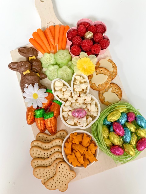 Easter snack board, Easter charcuterie board, Easter candy board, best charcuterie board ideas, best Easter charcuterie board, chocolate bunny charcuterie board, healthy charcuterie board for kids, cookie cutter charcuterie board, Easter candy charcuterie board, bunny cheese crackers, chocolate carrots, butterfly crackers, bunny cheese , foil covered eggs, R.M. Palmer