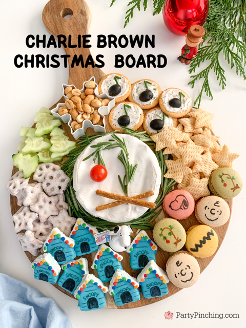 charlie brown Christmas charcuterie board, charlie brown snoopy christmas grazing snack board, best charlie brown christmas party food dessert snack movie ideas, charlie brown snoopy macarons, snoopy christmas doghouse blue cakes, schroder music note olive dip appetizers, peanuts gang charcuterie board ideas, brie charlie brown christmas tree rosemary tomato, cucumber christmas trees, charcuterie board for kids