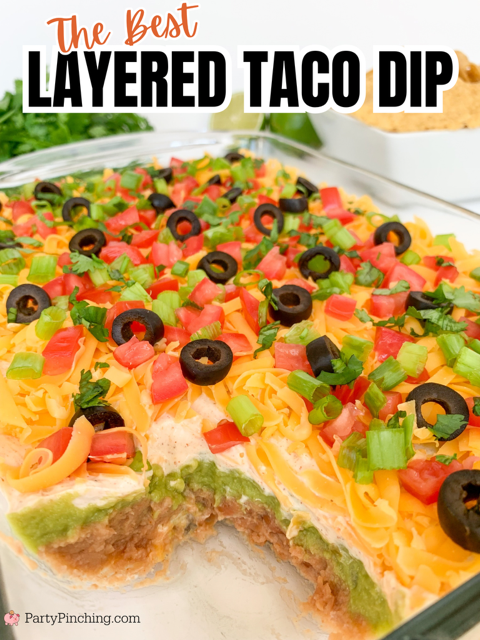 The best layered taco dip, easy best taco dip recipe, hot or cold taco dip recipe, easy appetizer dip for big game superbowl, best picnic potluck ideas for a crowd easy family friendly budget meals, beans guacamole sour cream taco seasoning tomato onion cheese olives lime taco dip