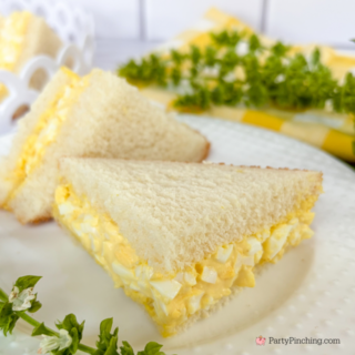 First boil the eggs for 20 minutes. Remove and put into bowl of ice water. Let cool completely. Next peel eggs and chop fine. Now add the mayonnaise, mustard, salt and pepper. Mix until thoroughly combined. Spread egg salad mixture on a piece of white bread. Top with another slice of bread. Cut the sandwich diagonally. Cut diagonally again for smaller sandwiches.