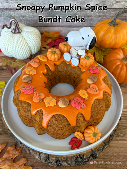 best easy Snoopy Pumpkin Spice Bundt Cake recie, Duncan Hines Snoopy The Great Pumpkin Bundt Cake and Glaze Mix, easy best fall cake, easy best pumpkin spice cake for fall, sweater weather Snoopy, Snoopy with a sweater, how to make Snoopy sweater with mini pumpkins and latte, fall decorated bundt cake with icing leaves and Trader Joe's chocolate pumpkins