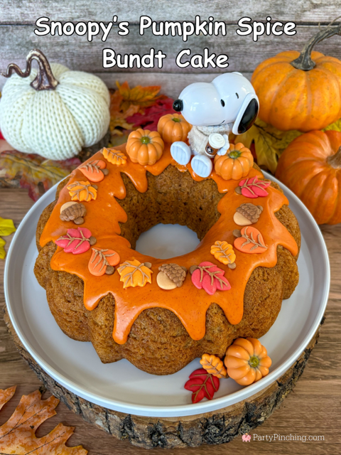 best easy Snoopy's Pumpkin Spice Bundt Cake recie, Duncan Hines Snoopy The Great Pumpkin Bundt Cake and Glaze Mix, easy best fall cake, easy best pumpkin spice cake for fall, sweater weather Snoopy, Snoopy with a sweater, how to make Snoopy sweater with mini pumpkins and latte, fall decorated bundt cake with icing leaves and Trader Joe's chocolate pumpkins
