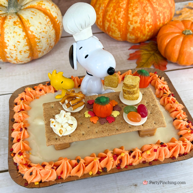 Snoopy's Thanksgiving Dinner Cake, Snoopy's Thanksgiving Feast, Snoopy Trader Joe's Mini Cake, Trader Joe's Mini Thanksgiving Cake, A Charlie Brown Thanksgiving, Snoopy, Charlie Brown, Woodstock, Jelly beans popcorn pretzels toast Thanksgiving dinner, easy no bake Thanksgiving dessert, Thanksgiving ideas for kids, best easy Thanksgiving recipes